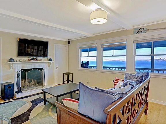 Living room includes a wood-burning fireplace.