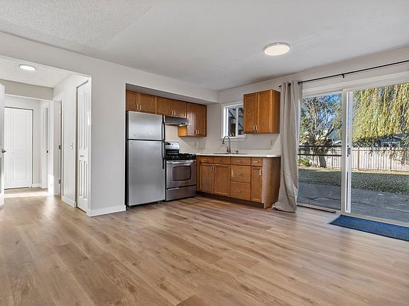 Roomy kitchen with sliding doors leading onto fully fenced backyard.