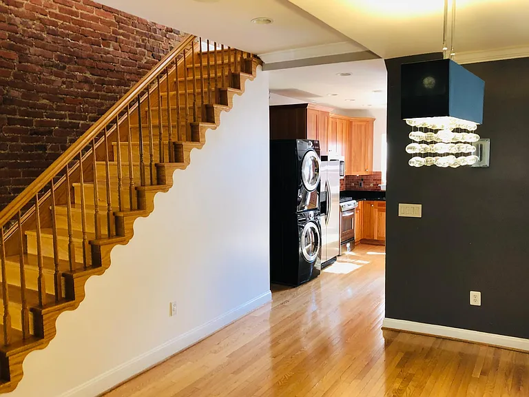 Open space design concept connecting dining room and open kitchen area. 1/2 bath is located to the right