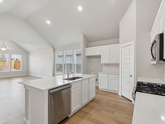 Kitchen in the Claret home plan by Trophy Signature Homes - REPRESENTATIVE PHOTO