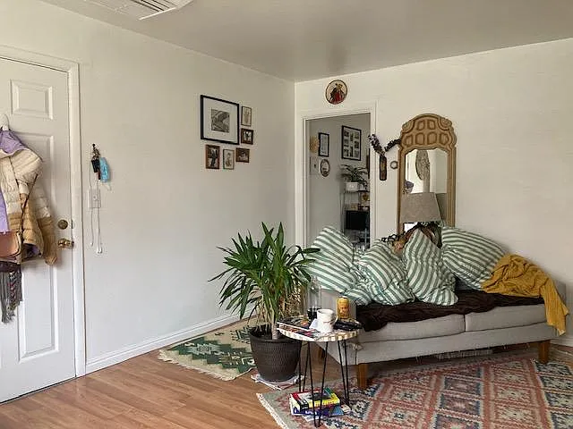 living room view toward entry door and kitchen