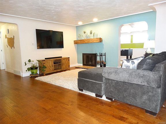 Living room with wood burning fireplace.