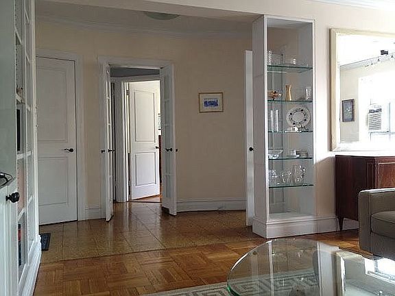 View from the living room into the foyer and bedroom beyond.
