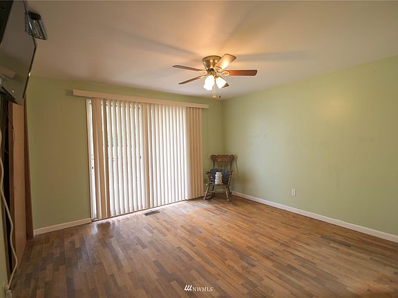 Master Bedroom with Wood Floors, Sliding Door to back yard, and Ceiling Fan>