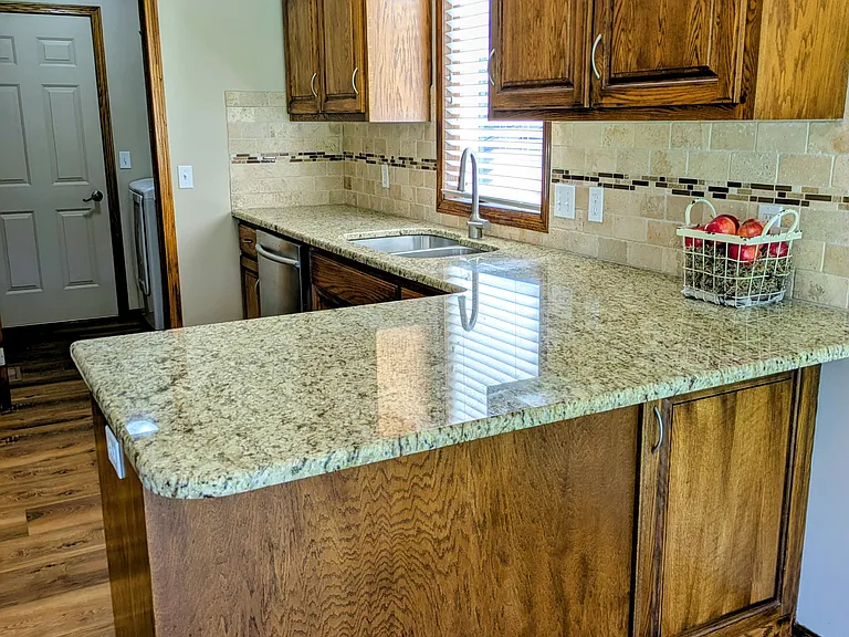 Dark oak cabinets, with snack bar area.