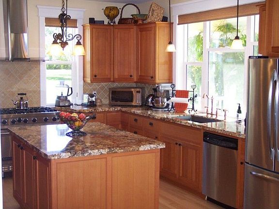 The large chef's kitchen features custom cabinets, one of a kind granite, top end appliances and a very roomy and spacious layout.