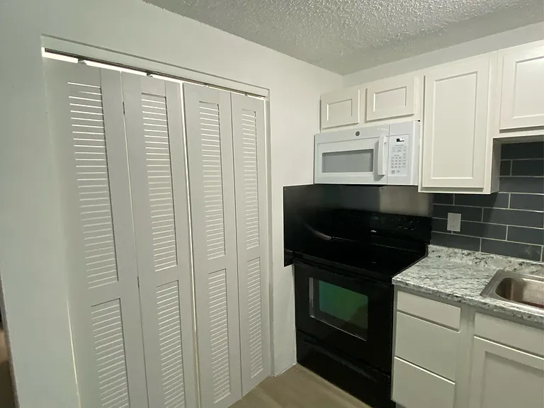 Kitchen photo B Louver doors laundry hookups area