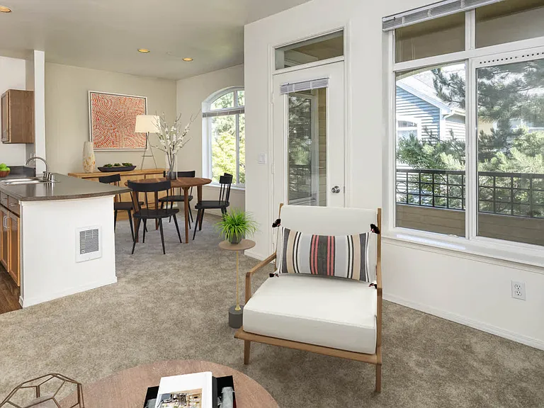 Carpeted Living Room with Balcony