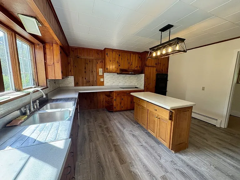 Large kitchen with island and space for a table and chairs.