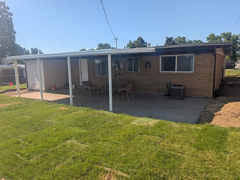 This covered patio is simply amazing! Imagine sitting on the chair curled up with a great book and a cold lemonade enjoying the beautiful summer nights!