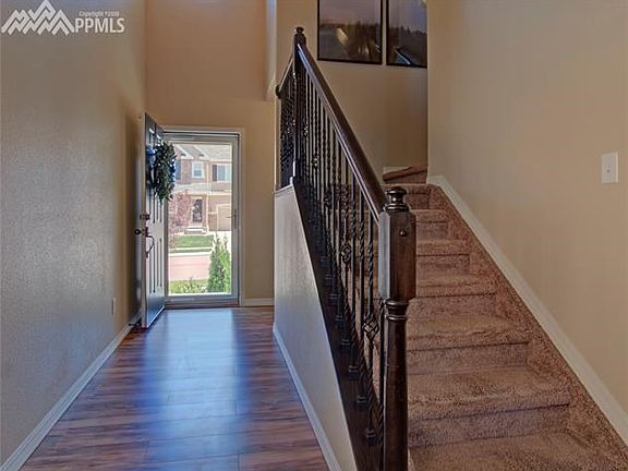 Vaulted two story entry with 1/2 bathroom and coat closet conveniently right inside the front door.