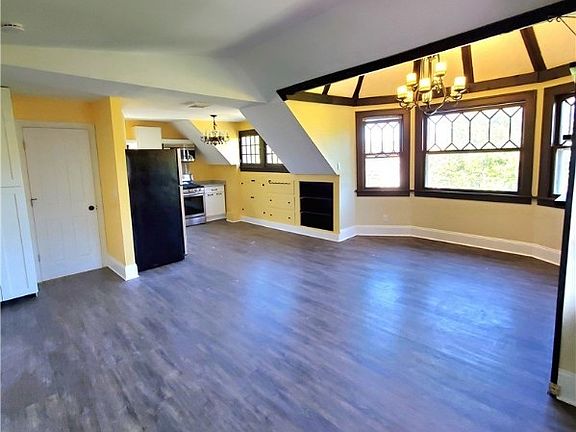 Kitchen and large living space under an original Turrett. Large windows and engineered flooring.