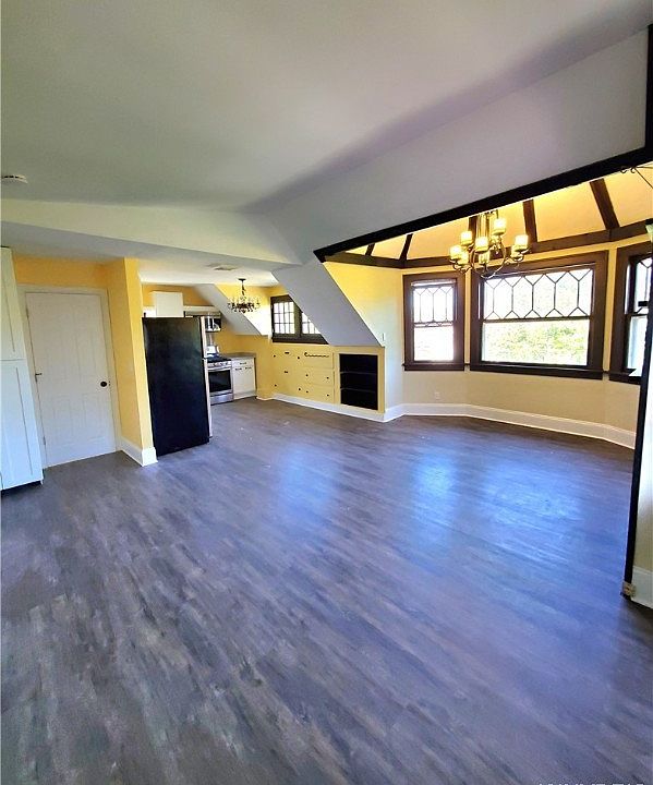 Kitchen and large living space under an original Turrett. Large windows and engineered flooring.