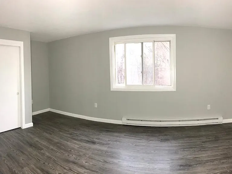 Primary bedroom with large window and closet