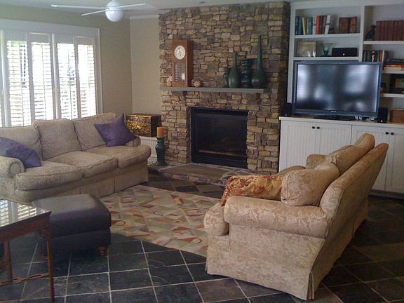 Great Room.  Stone fireplace, heated slate floors, French doors to patio