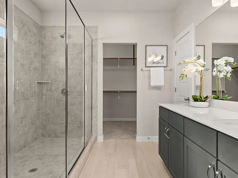 Large master bathroom has a walk-in shower and lots of storage.