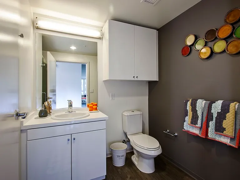 Bathroom with white cabinetry, white countertop and hard surface flooring