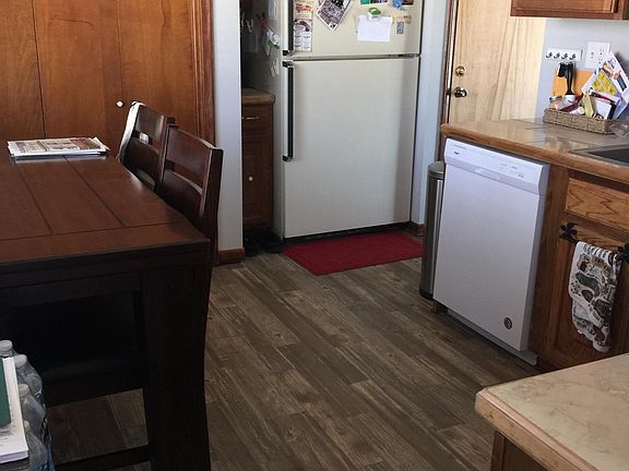 Kitchen with range, refrigerator, built in microwave, disposal and laundry closet.