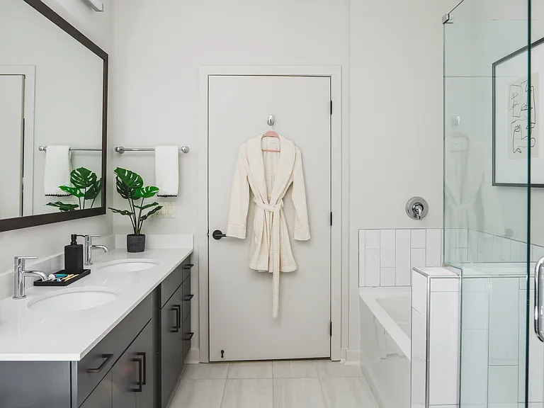 Designer bathrooms with quartz countertops, dual vanities, and soaking tubs