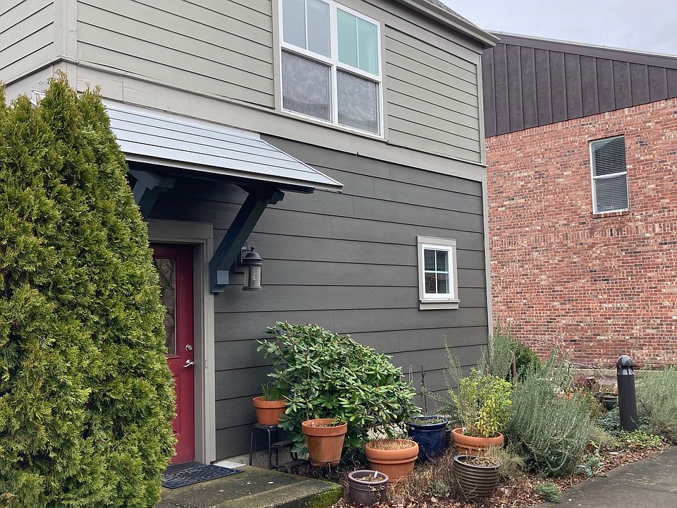 Apartment is upstairs above a garage. Apartment entry is through the red door.