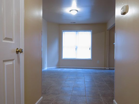Downstairs hallway looking into family room with huge hall closet on left