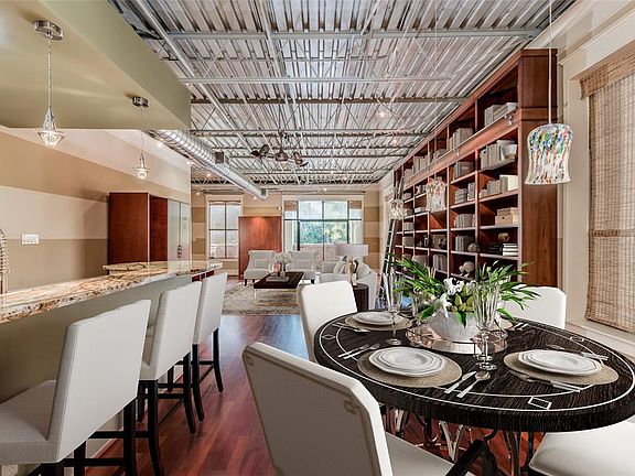 A view from the dining area into the living area to highlight how large and spacious this loft truly is! Also note the beautiful exposed ceiling that compliments the lofts openness.