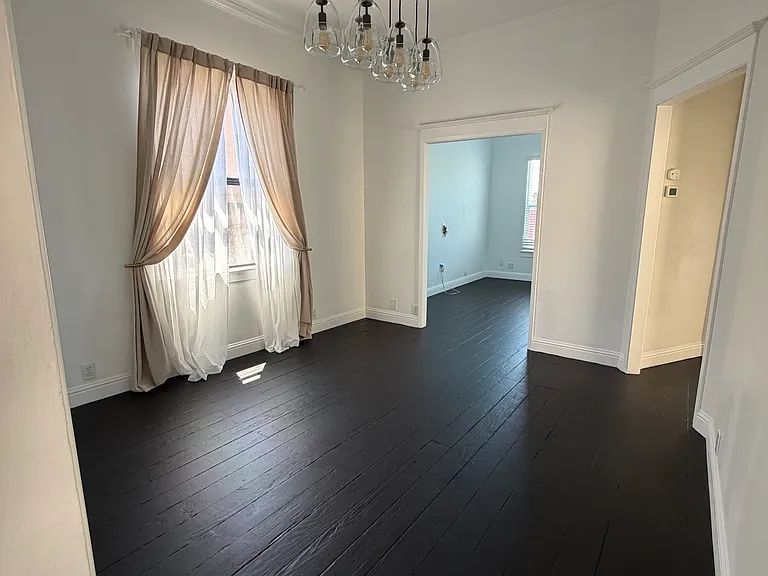 Dining room overlooking the shared backyard, complete with a beautiful dimmable chandelier for the perfect balance of natural light and evening ambiance.