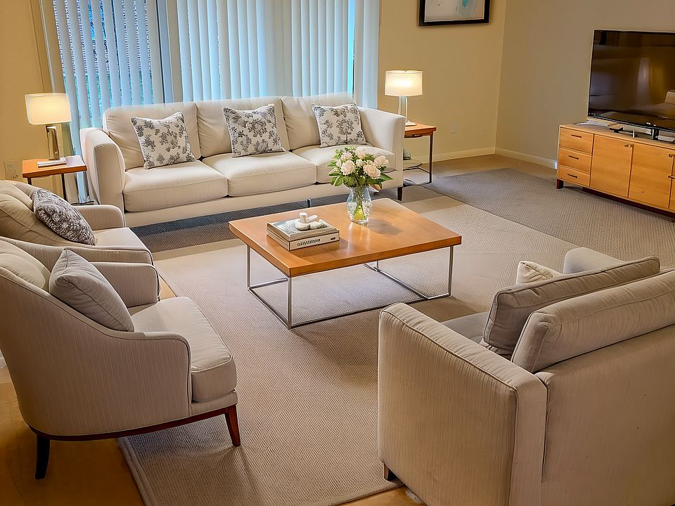 The living room has a triple-sliding door, providing lots of natural light.