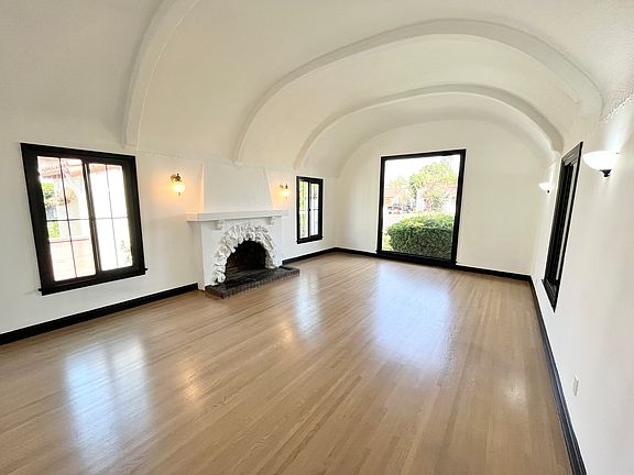 Living Room w/ High Ceilings and Decorative Fireplace