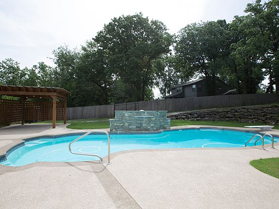 Private Backyard is enhanced with mature shade trees, privacy fence and landscape boulders.