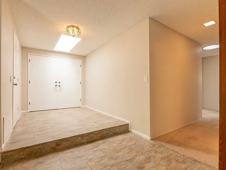 Main entrance with garage door to the right.