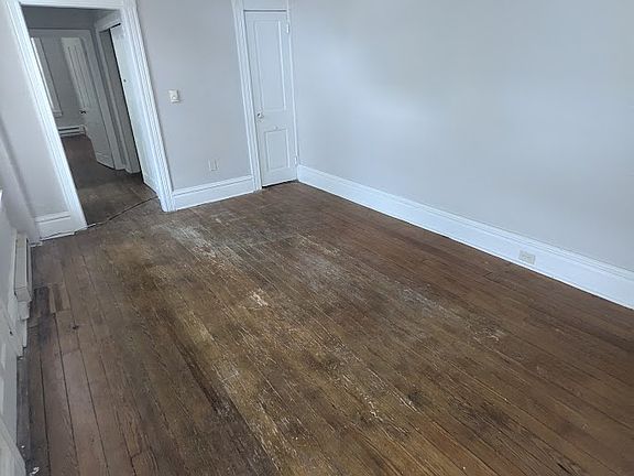 Living room with hardwood floors and closet
