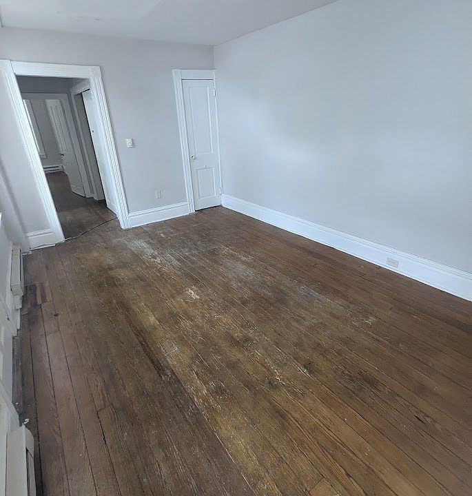 Living room with hardwood floors and closet
