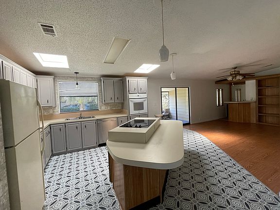 Kitchen with door to screen porch.