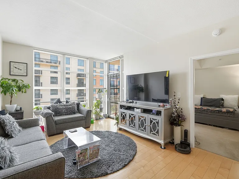 Bright living room with large windows and city views