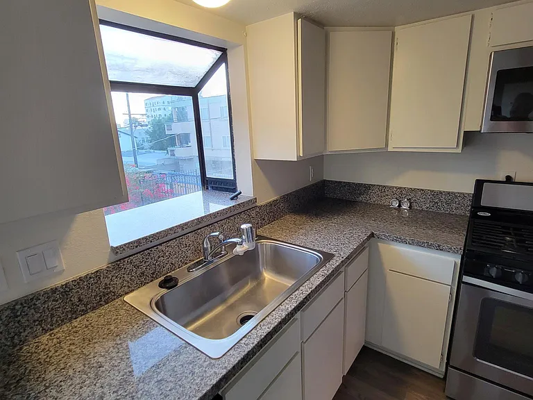 Kitchen: Granite Countertop, Dishwasher, Stainless Steel Sink w Garbage Disposal, Stove, Microwave & Lots of Cabinets