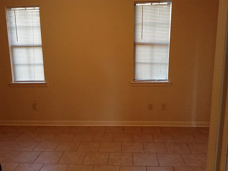 Bedroom. Room for queen bed between the windows.