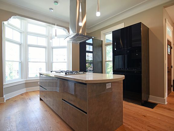 Unusual window arrangement allows, optimum light into the kitchen, and view of the garden.