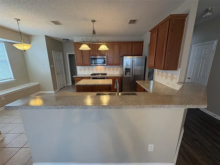 GRANITE COUNTERS, NEW SS DOUBLE SINK, ISLAND WORK STATION AND OPEN TO THE DEN.