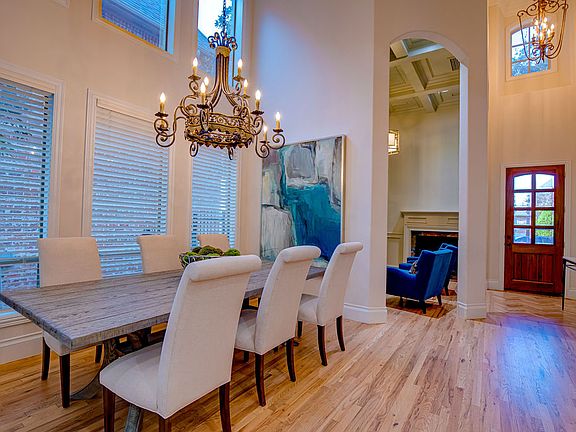 Upon entry, enjoy an office/study with a cozy fireplace, built-in shelves and high ceilings adjacent to the dining room and kitchen