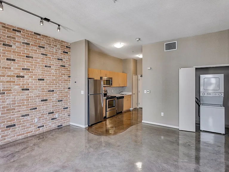 Our loft style homes include polished concrete flooring with a brick accent wall