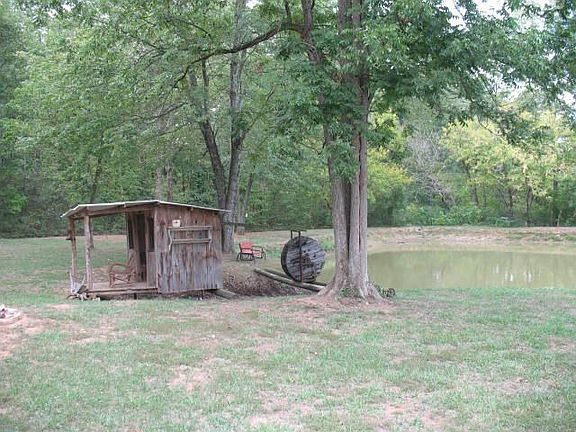 stocked pond in backyard w/ quaint little 'catfish' house (power & water)