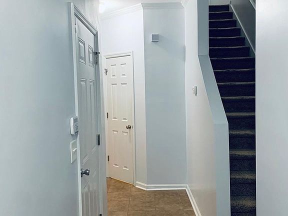Welcome home! Tiled entryway. Garage door to the left and half bath to the right.