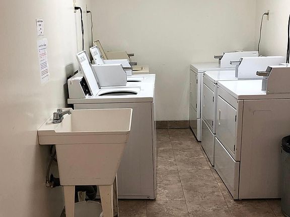 Shared coin laundry with coin machine in room to dispense change