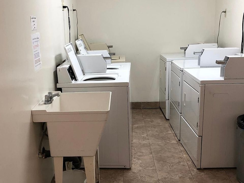 Shared coin laundry with coin machine in room to dispense change