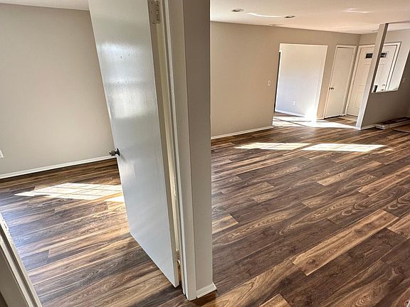 View of Living Room, Dining Room, Entrance to Den & Bedroom.