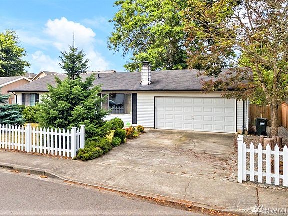 White picket fence leads to driveway and to huge 600 sq ft garage! 