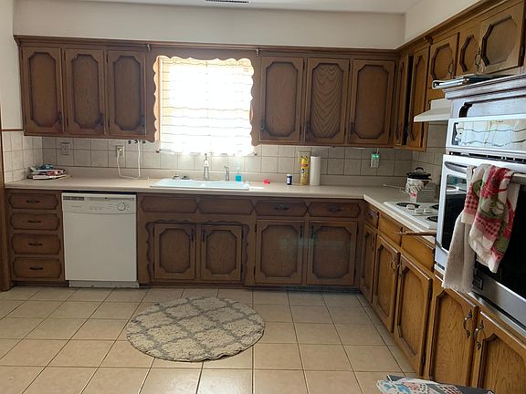 Kitchen with new convection oven and built in china cabinet, tile flooring
