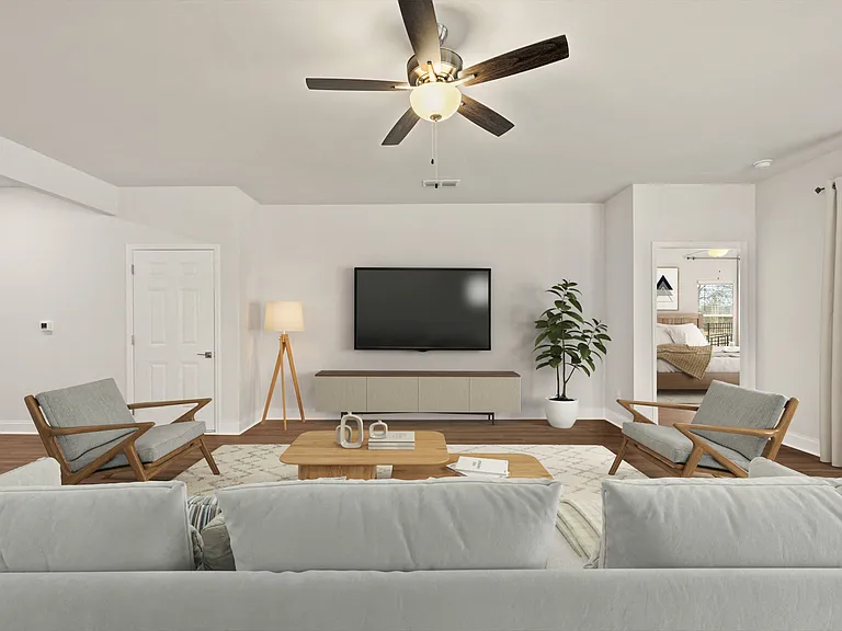 Living room with large window letting in a ton of natural light.