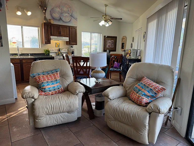 Comfy reclining chairs in large family room and kitchen.